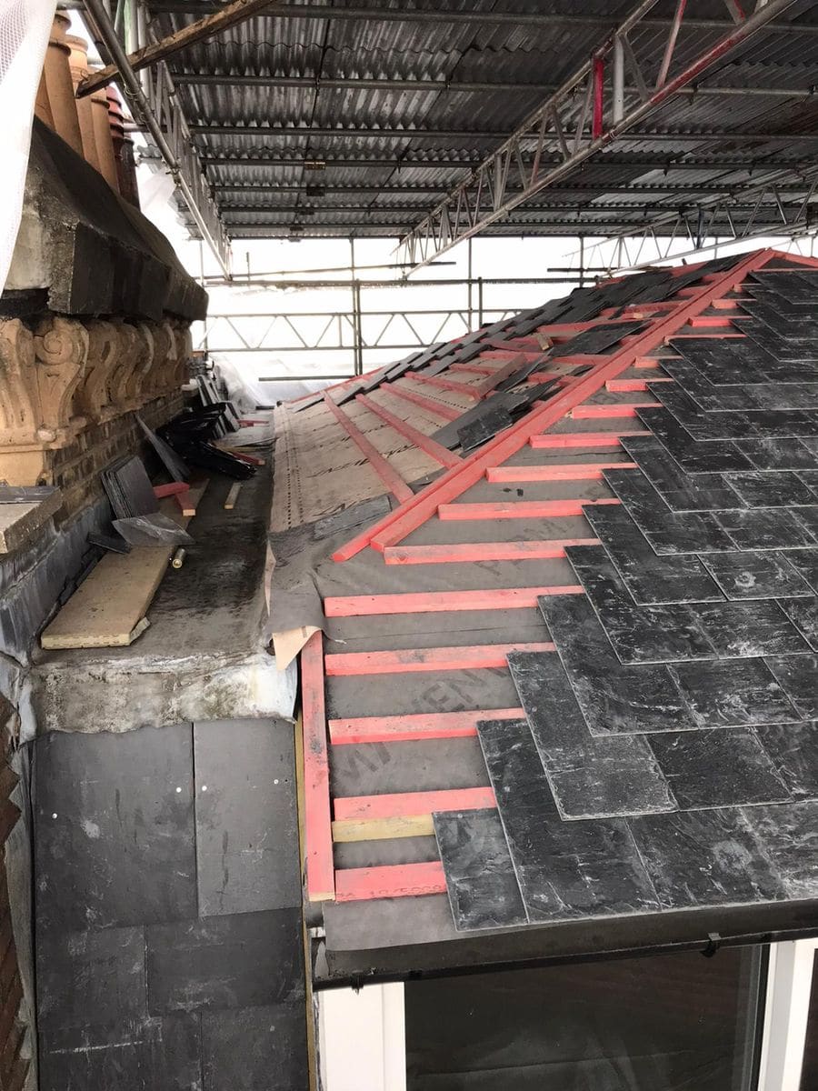 Deteriorated roof tiles on a Victorian terrace in Kensington before replacement