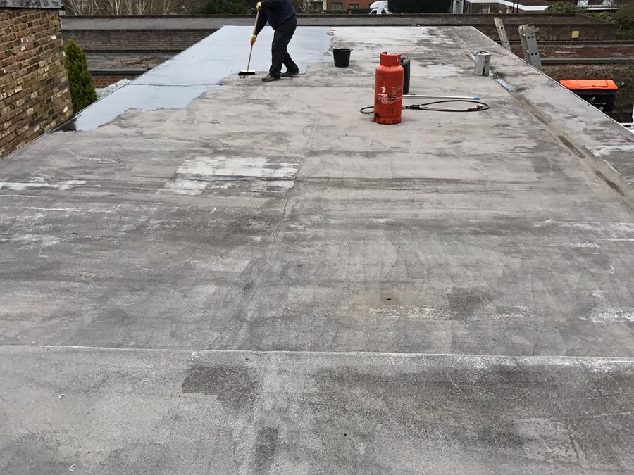 Damaged flat roof on a commercial office building in Central London before repair